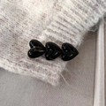 Detailed macro view of black glossy heart-shaped hair clip with gold Handmade France engraving - French Handmade Heart Duckbill Clip / Black