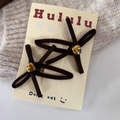 Detail of suede bow hair clips in brown with golden heart accent on a knitted sweater - BB Clips / Dark Coffee