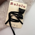Detail of black leather bow hair clip and velvet ribbon set on cream display card - Black Bow BB Clip