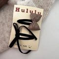 Detail of coffee glossy and black velvet bow hair clips on card over knit background - Khaki Bow Snap Clip
