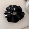 Detailed view of bicolor black satin scrunchie with white polka dots pattern - Black Polka Dot