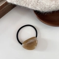 Close-up of a minimalist amber resin geometric charm on a high elasticity hair tie - Milk Coffee