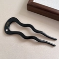 Elegant wave-shaped U-style acetate hair pin in shiny black with a sparkling crystal stone - Black