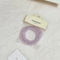 Dettaglio di elastici a spirale viola trasparente con confezione di vendita - Set di 2 pezzi / Viola