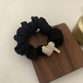 Detail view of a black scrunchie with a pearl heart charm and a gold handmade metal tag - Heart Style (FQ-082-HX058) / Black