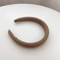 Detail of light brown padded headband featuring thick fabric and premium stitching - Brown
