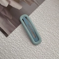 Detail view of a matte mint green oval hair clip on a textured white fabric background - 9# Light Blue