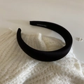 Detailed view of handmade black satin padded headband featuring an interior fabric label - Black