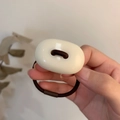 Detail showing high-gloss cream resin oval charm and brown elastic hair tie - Milky White