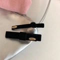 Detail of black velvet bow hair clips with gold engraved metal centerpiece and high texture - Black