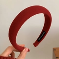 Close-up of handmade wide ribbed knit headband in deep red with a sewn label detail - Twill Style