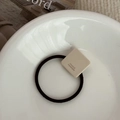 Black elastic hair tie with beige square charm featuring France Handmade text design - Off White