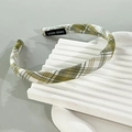 Detail of green and white plaid fabric headband with a woven HAND-MADE label inside - Green Check