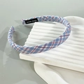 Plaid pattern woven headband in blue and red on a minimalist white display stand - Blue Plaid