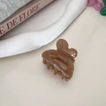 Detail of amber heart hair claw clip with Barrette la France logo on decorative plate - Light Coffee