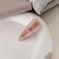 Detail of pink marble acetate triangular hair clip on a white ceramic tray display - Long Triangle Marble Style (4#)