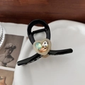 Elegante zwarte hartvormige haarklem met kleurrijke strass-steentjes op keramiek bord - Zwart