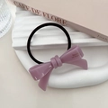 Detail of purple acetate bow hair tie with golden logo on a white aesthetic tray - Light Purple