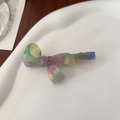 Detail view of iridescent acetate bow hair clip with France Handmade engraving - Rainbow
