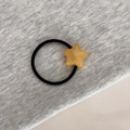Detail of yellow star resin charm on black elastic hair tie with France handmade text - Yellow