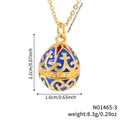Detailed close-up of retro blue enamel egg pendant with gold floral engravings - Blue
