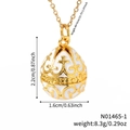 Vintage gold-toned egg pendant necklace with white enamel and ornate floral cross pattern - White