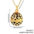 Vintage gold egg pendant necklace with black enamel floral patterns on white background - Black