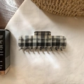 Close-up of a rectangular black and white plaid hair claw clip on soft white fabric - Black and White Plaid Square Claw Clip