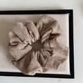 Detail shot of chunky oatmeal knitted hair scrunchie with thick ribbed texture and pleats - Milk Tea