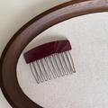 Detail eines französischen Haarkamms mit burgunderfarbenem Acetat und zehn Metallzinken - Transparentes Weinrot