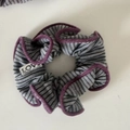 Detailed shot of striped gray knit hair scrunchie with velvet trim and LOVE label - Purple Edge Khaki Striped Gray