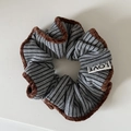 Macro detail of grey striped hair scrunchie with brown velvet trim and brand label - Coffee Edge Khaki Striped Gray