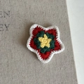 Close-up of handmade crochet Christmas star clip with red green yellow and white yarn - White Edged Red Star Clip (7#)