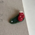 Close-up of handmade crochet Christmas sock hair clip with pearl and gold thread details - Red Christmas Sock Green Clip (12#)