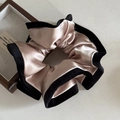 Detail of satin and black velvet hair scrunchie with soft sheen on wood tray - Champagne Black Edge