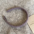 Detail of purple knitted wool headband with soft plush texture for winter style - Purple