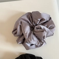 Close-up of soft dusty purple satin scrunchie with silky texture and voluminous pleats - Purple Satin