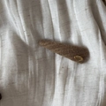 Detailed texture of a brown knitted hair clip with a gold 'Hand Made' metal badge label - Milk Tea Long Triangle Style (2#)