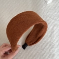 Detail of a brown knit headband with fine texture and durable wide-brimmed design - Caramel Striped Knitted Headband