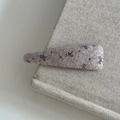 Close-up of lilac wool hair clip with black bow patterns on a fabric background - Creamy White Long Triangle Bowknot Style