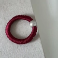 Close-up of a burgundy silk scrunchie with a large decorative pearl bead accessory - Burgundy