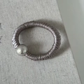 Close-up of a light purple satin hair scrunchie with a polished silver metallic bead accessory - Champagne