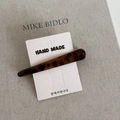 Detailed macro view of a tortoiseshell leopard print hair clip on a handmade card - Long Duckbill Clip / Coffee Leopard
