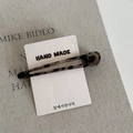 Macro shot of leopard print acetate hair clip on a handmade card with minimal aesthetic - Hollow Long Duckbill Clip / Grey Leopard