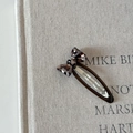 Detailed view of a leopard print acetate hair clip on a natural linen background - Coffee Clip Leopard Bow