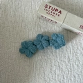 Macro shot of blue handmade crochet flower hair clip with detailed knit texture - Light Blue