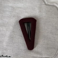 Close-up of deep red knitted fabric BB hair clip with detailed stitch texture on grey surface - Large Triangle Hair Clip / Brick Red