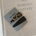 Detailed view of leopard print and matte black hair clips on a New Fashion display card - Leopard And Black Triangle Style