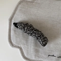 Close-up of vintage floral fabric texture on the grey banana hair clip accessory - Gray White Floral