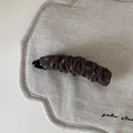 Macro detail of dark brown floral fabric banana clip showing pleated texture and pattern - Khaki Milk Tea Floral